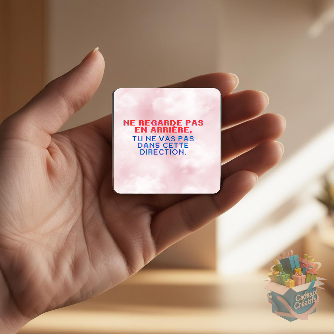 Tenant un aimant de réfrigérateur avec une citation inspirante.